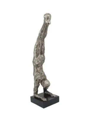 Metallic human form in handstand pose
